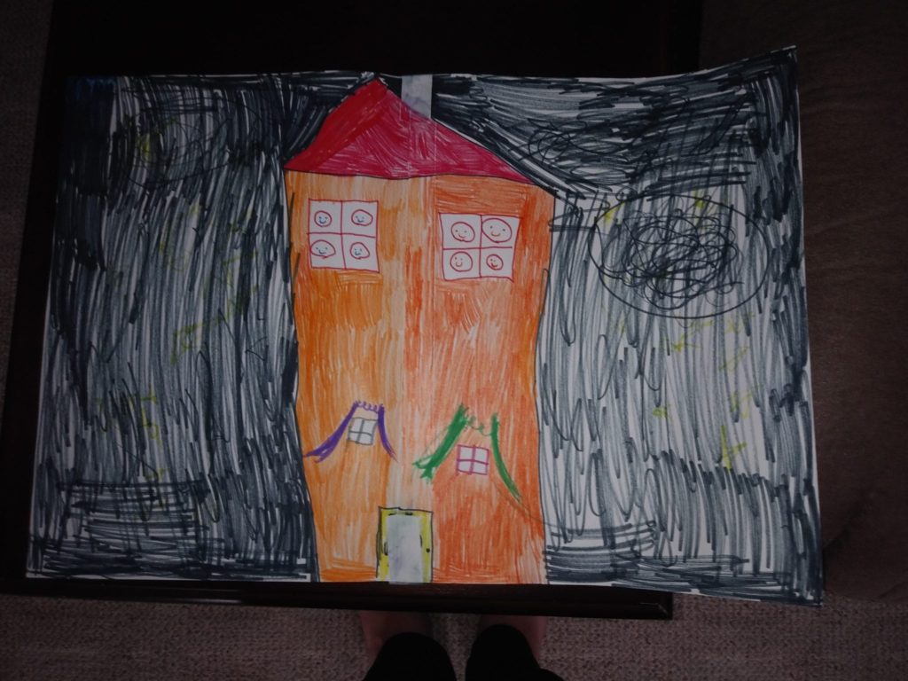 Drawing of an orange house with happy faces in the windows and a black night sky.