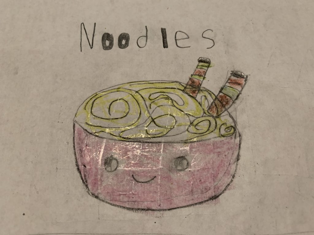 Here is a student drawing of a bowl of noodles with a smiling face on the bowl