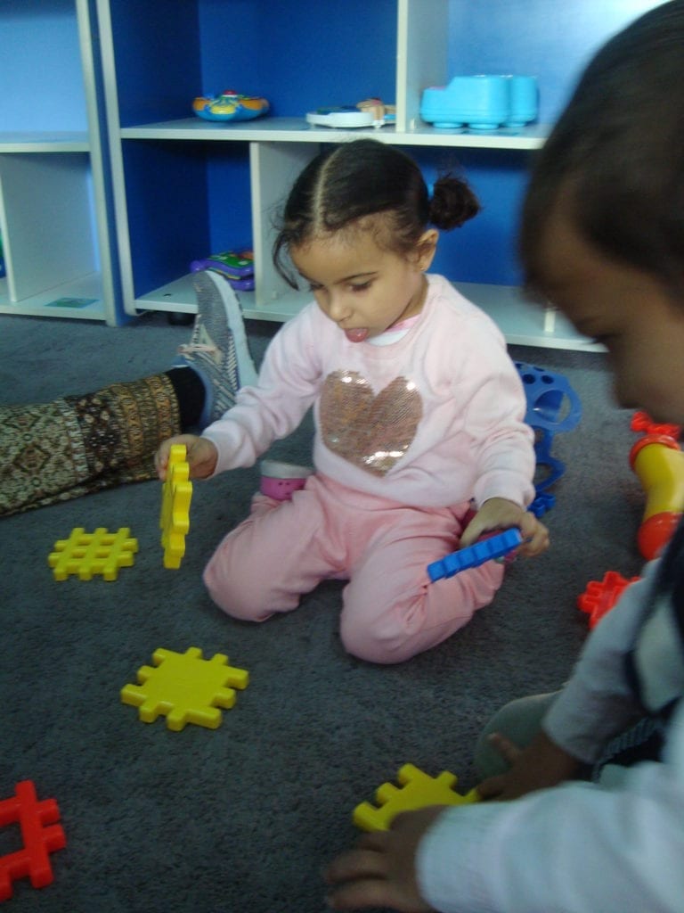 student playing with waffle lego