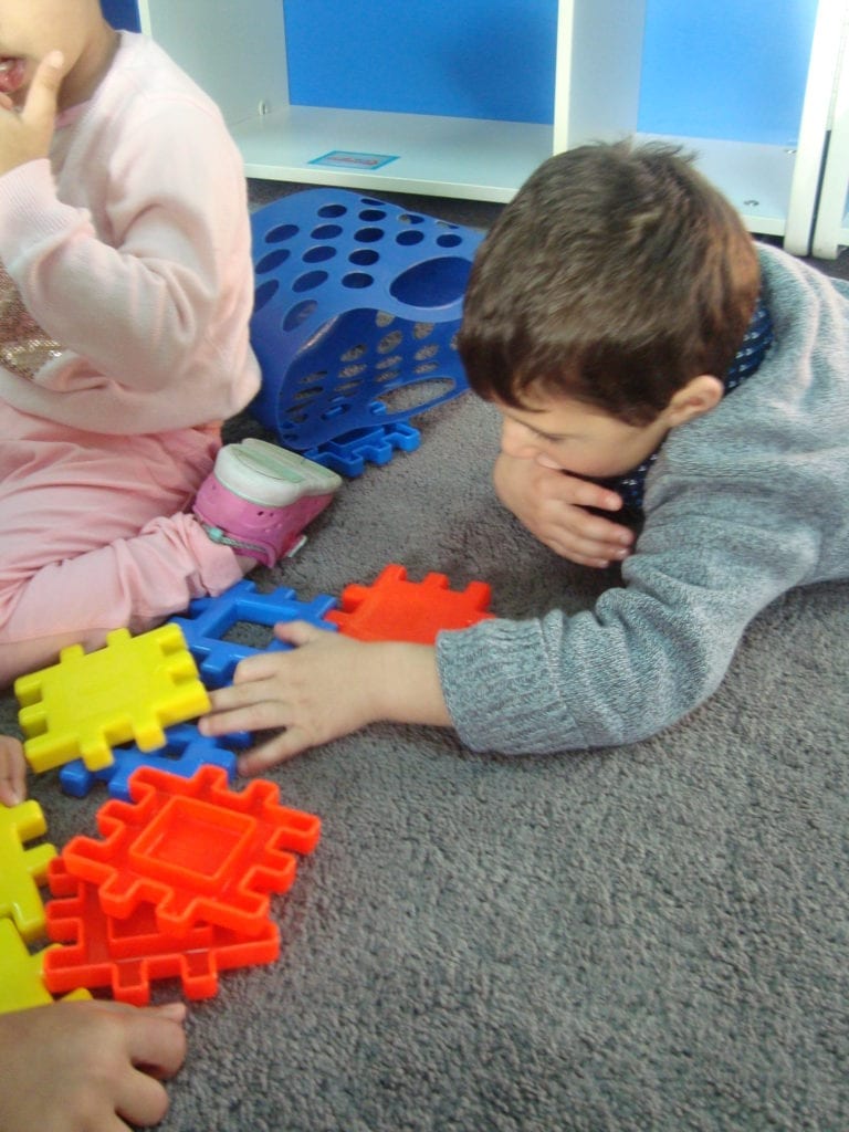 student playing with waffle lego