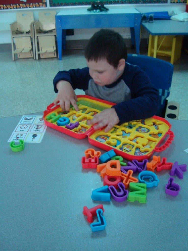 student working on alphabet puzzle