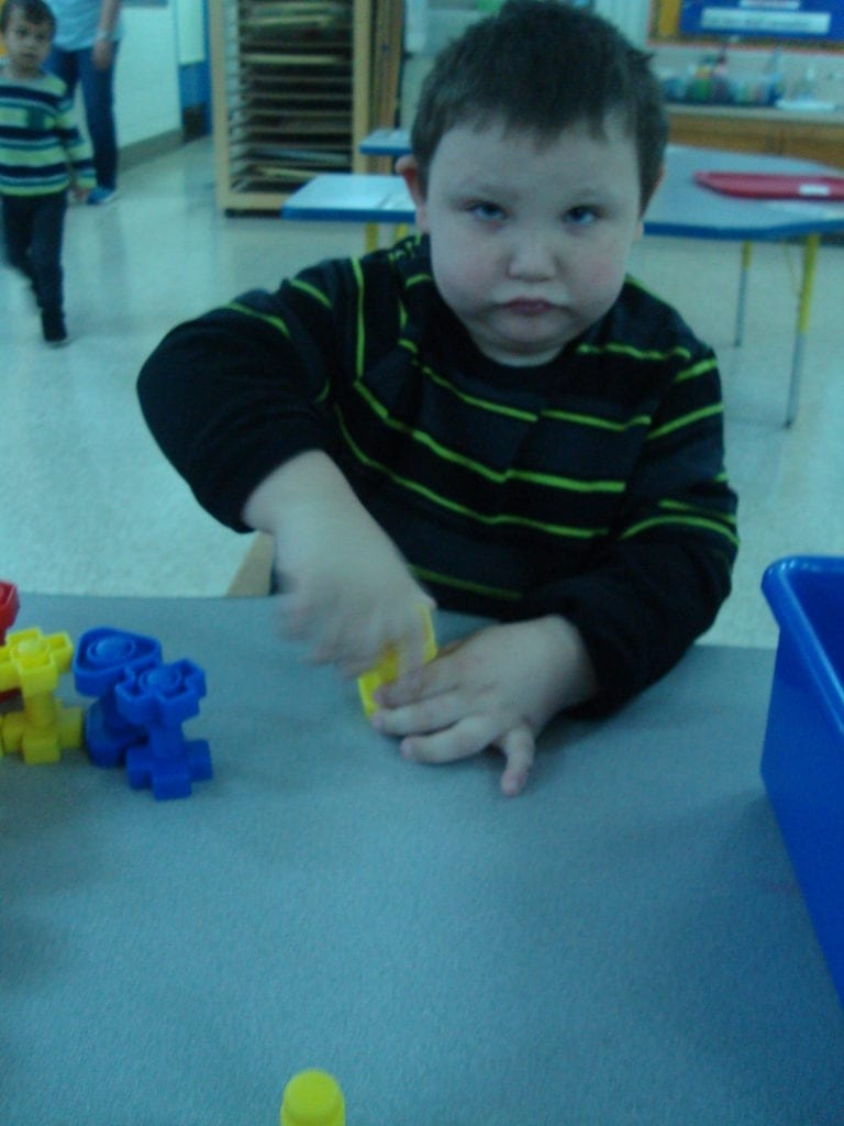 student playing with nuts and bolts
