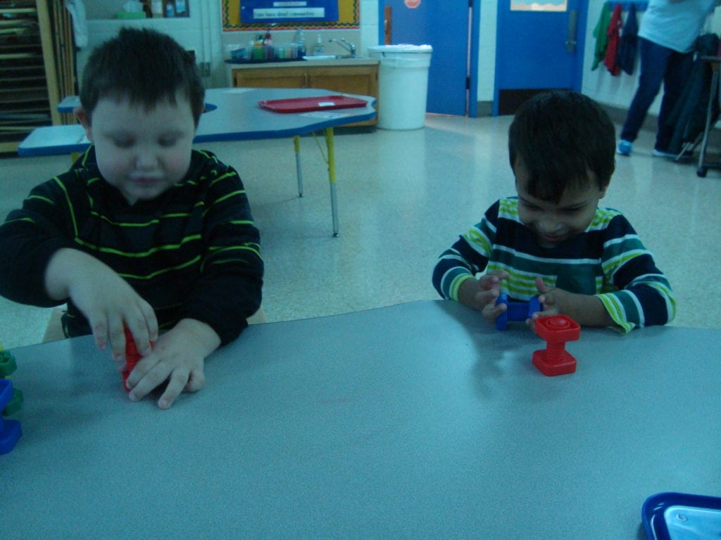 student playing with nuts and bolts