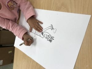student hands drawing the statue of liberty