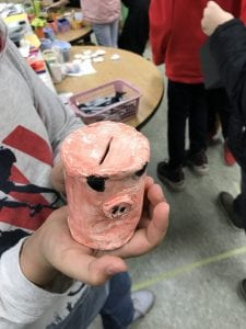 pink cylinder bank with black eyes and a pig nose
