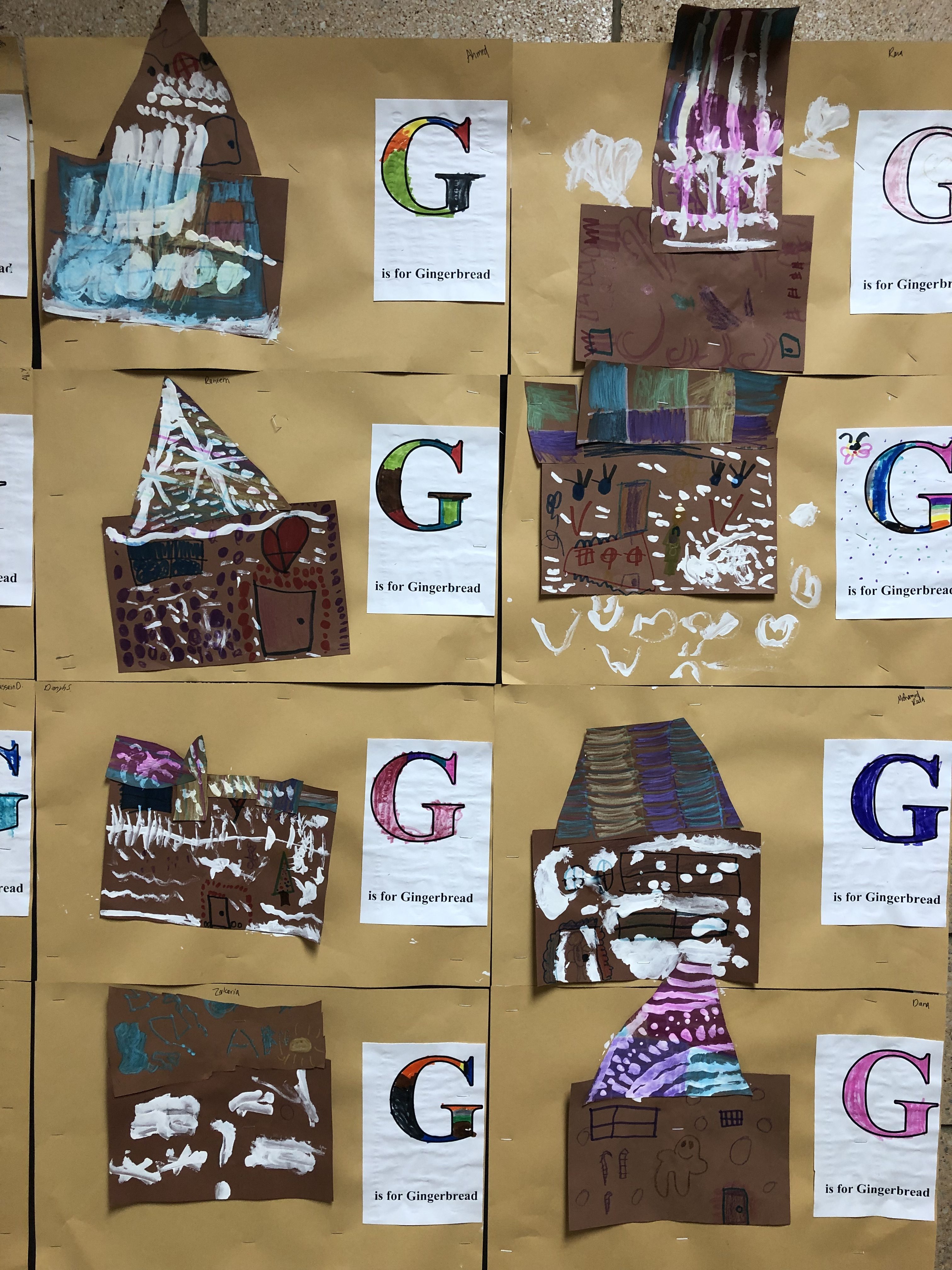 paper gingerbread houses with white paint details made by Kindergarten students