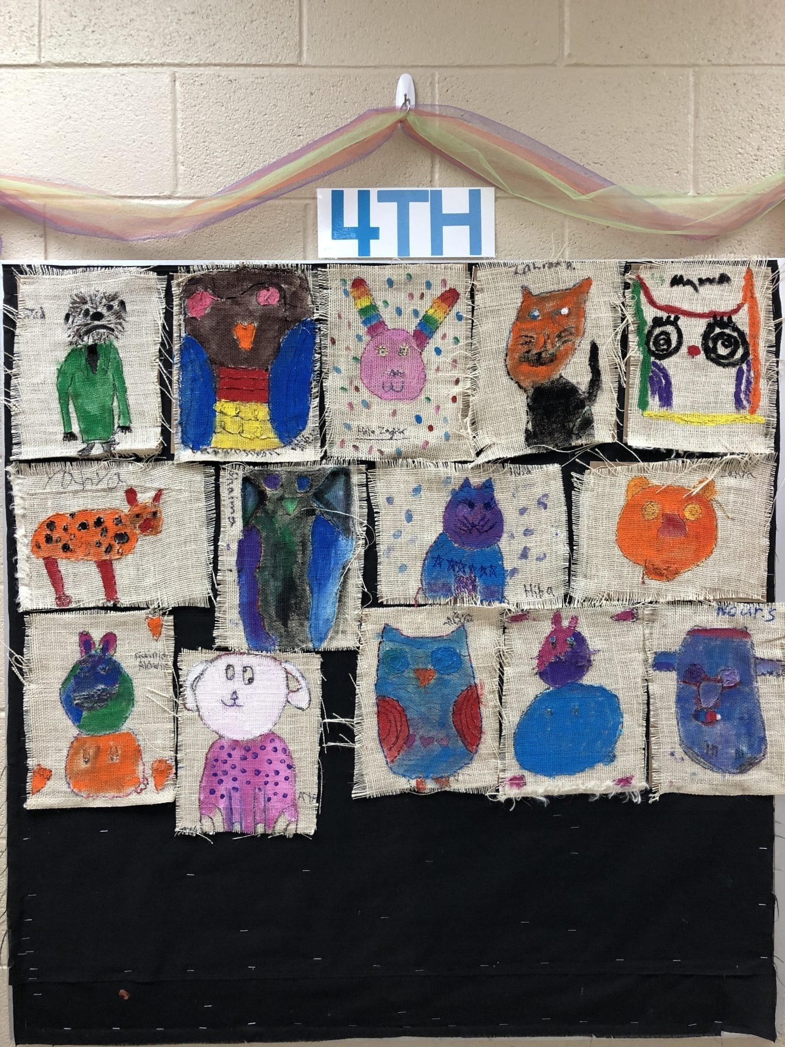 Animal drawings on burlap. Fourth grade students practiced sewing a running stitch in the burlap.
