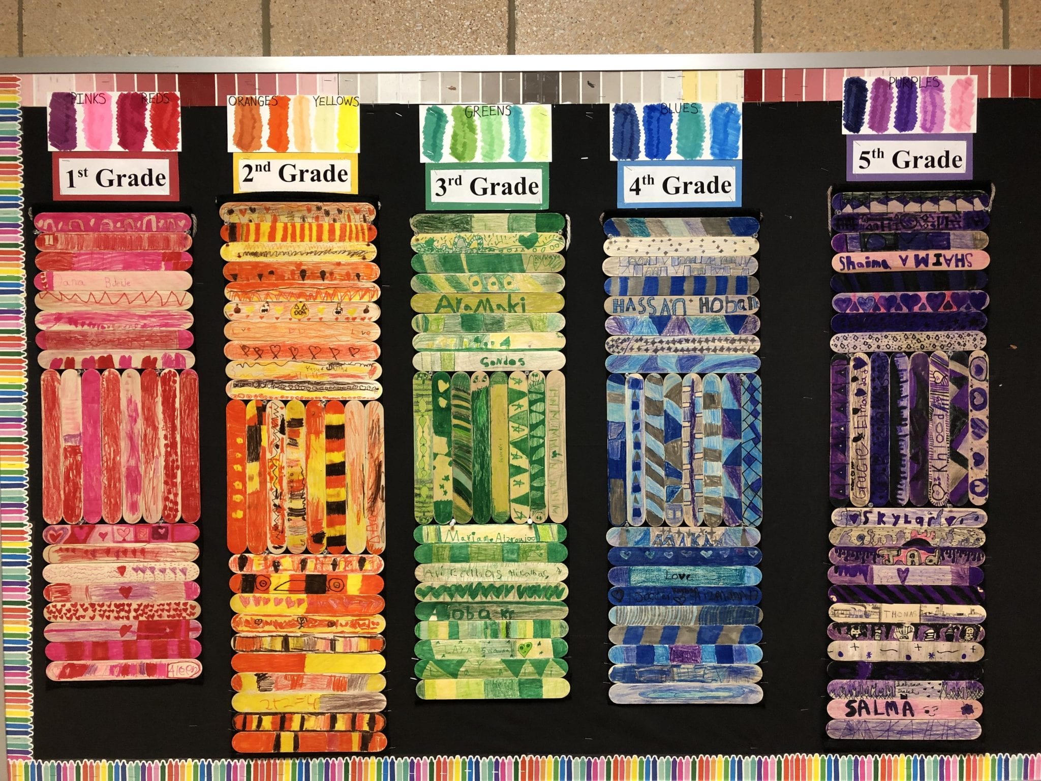 wall hangings made from large craft sticks glued to felt
