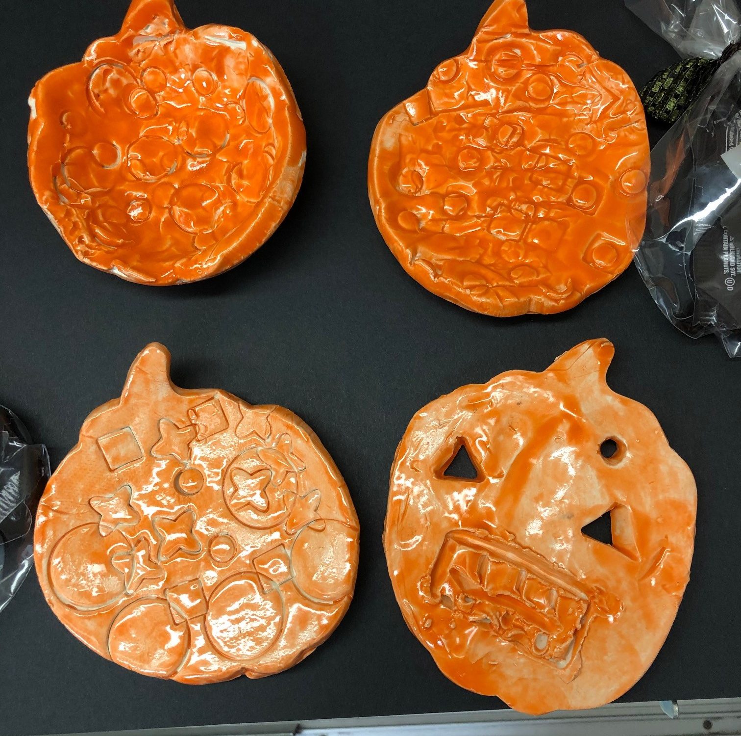 pumpkin shaped small clay bowls painted with orange glaze