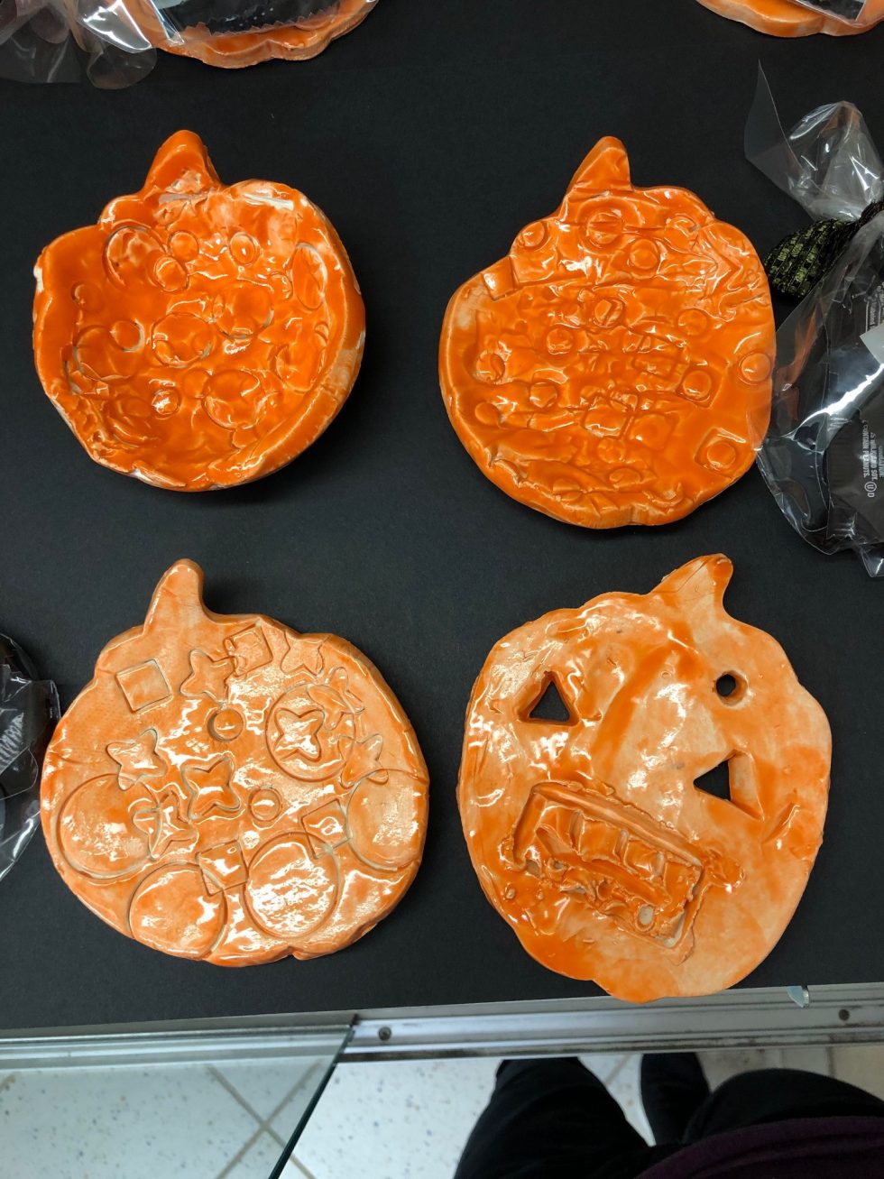 pumpkin shaped small clay bowls painted with orange glaze