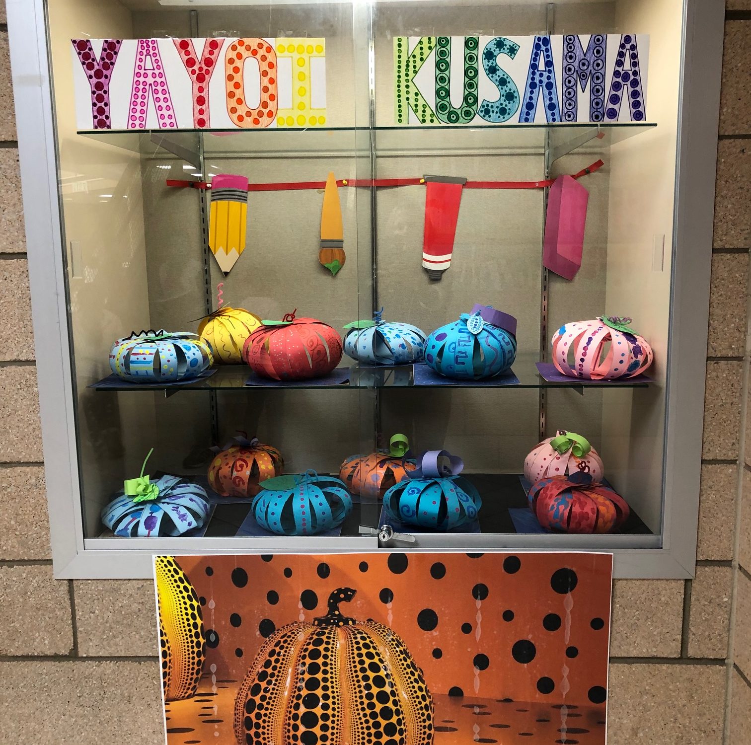 pumpkin sculptures made from paper strips put together with a pipe cleaner and glued to a cardboard base