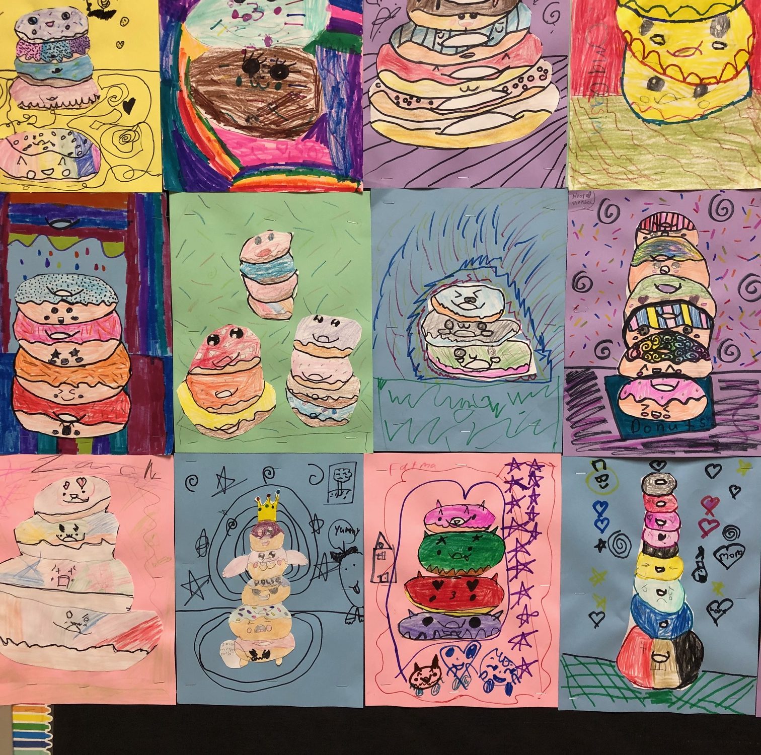 drawings show donut stacks with cartoon faces and decorations for frosting by third graders