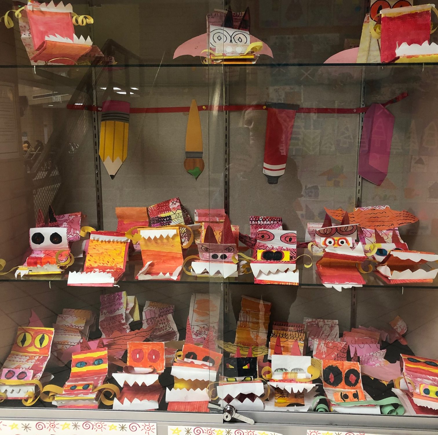 dragon puppets for Lunar New Year made from construction paper by 4th grade students