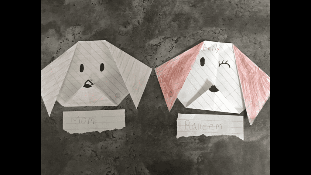 origami dog heads with drawings of faces on them