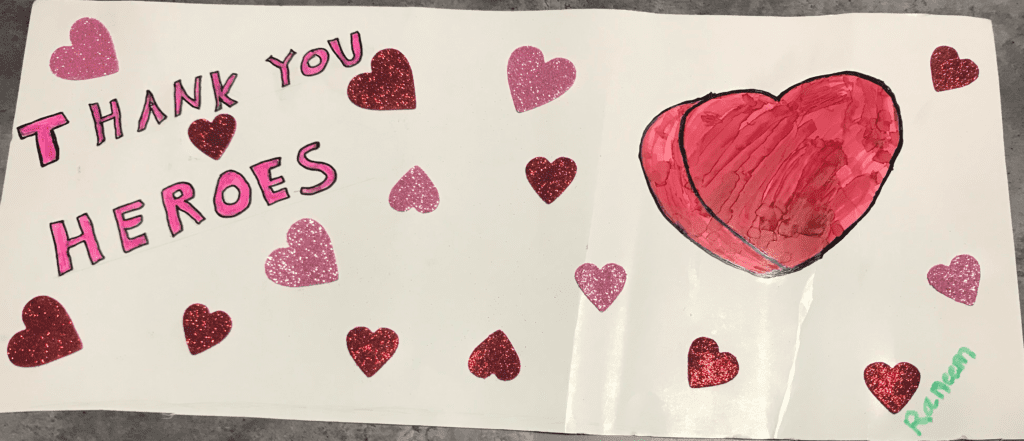 Large three-dimensional heart with glitter heart stickers and thank you heroes message
