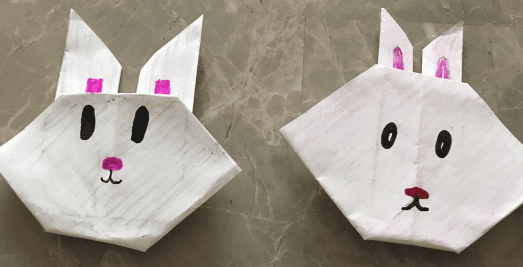 folded paper origami bunnies with drawn faces