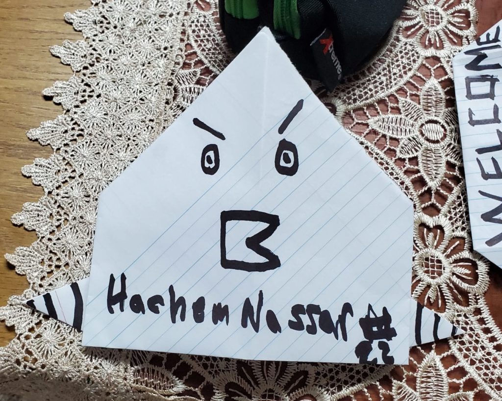 origami chicken folded from paper with a drawn face