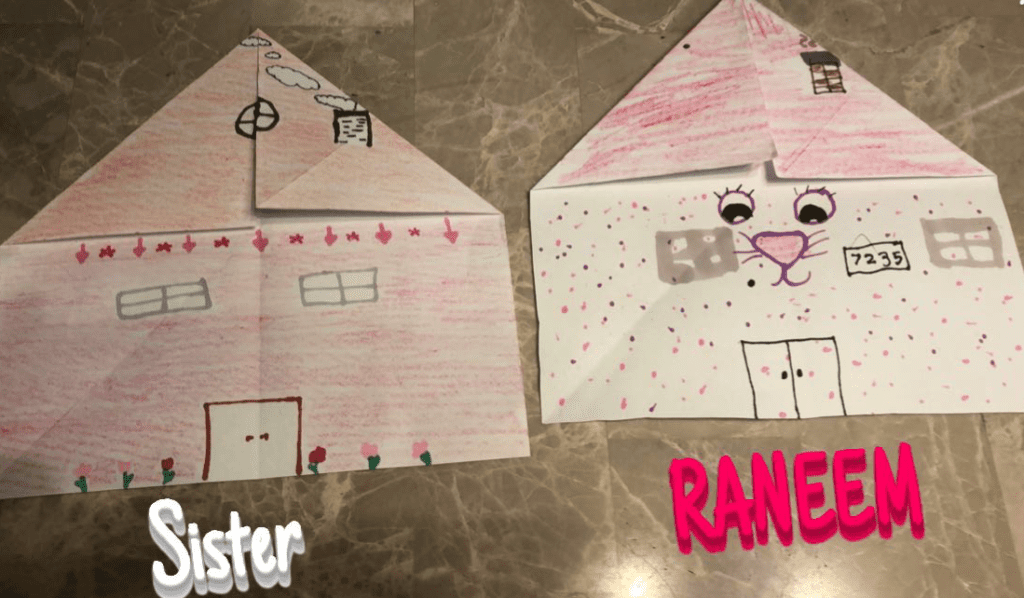 folded origami house with drawings of doors and windows on them