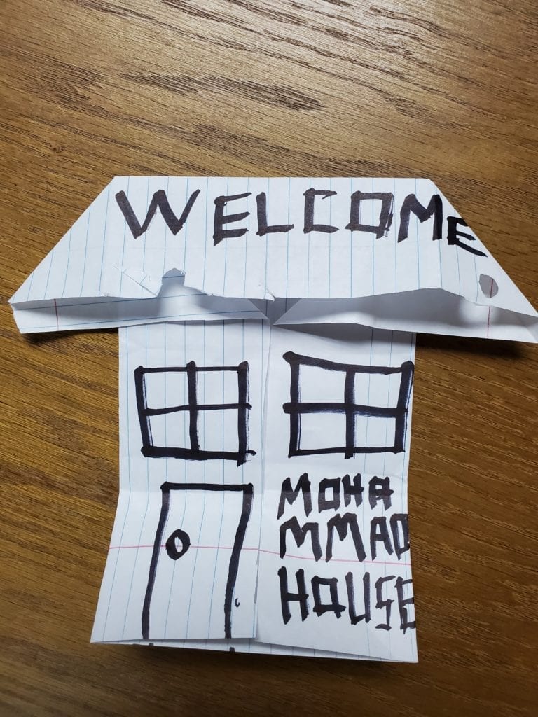 folded paper origami house with drawn details