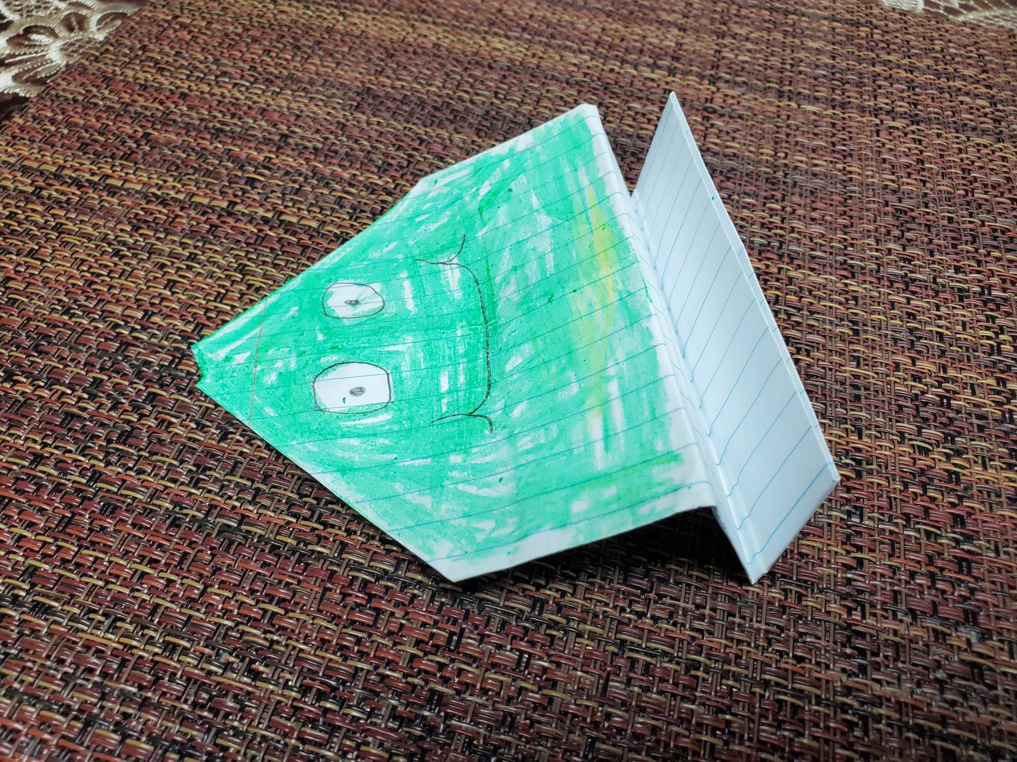origami jumping frog made from paper and colored green