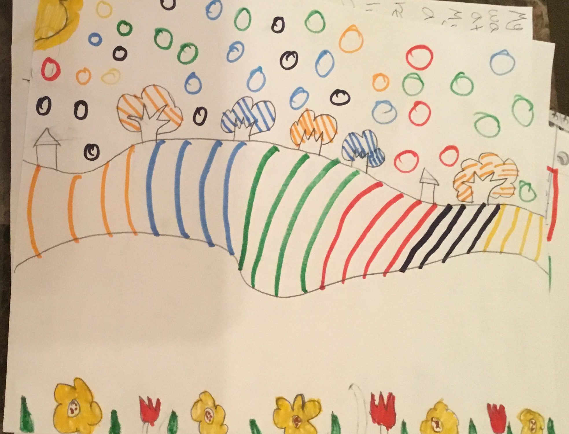 drawing of a landscape with rainbow lines for hill and circles in the sky