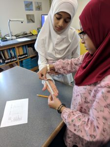 Student measuring hand.