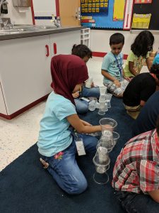 Students stacking cups