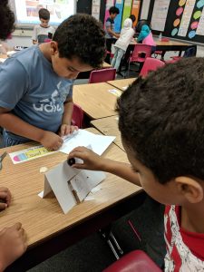 Student using a magnet to open the door.