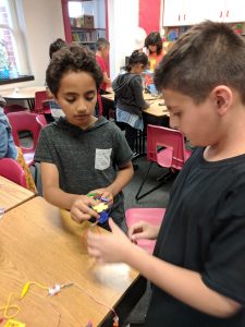 Students making a fan work.