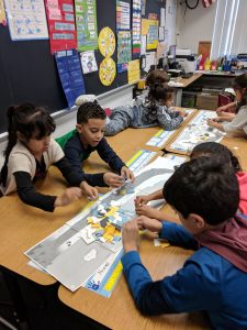Students making sand from rocks