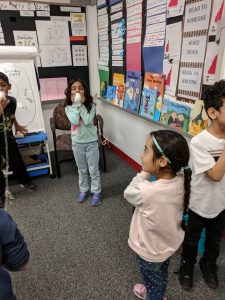 Students using cup phones.