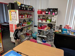 Students using cup phones.
