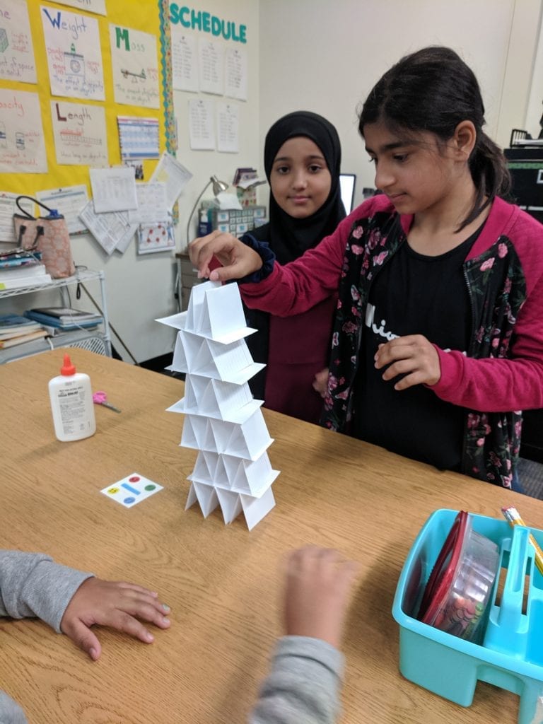 Students creating a tower with index cards.