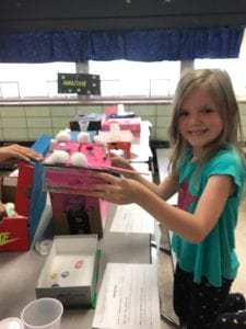 girl showing off science project