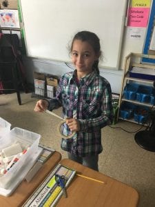 a girl shows her project