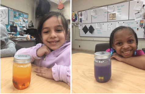 two girls showing their mindfulness jars in the art room