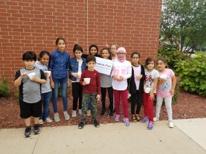 12 students, one holding sign