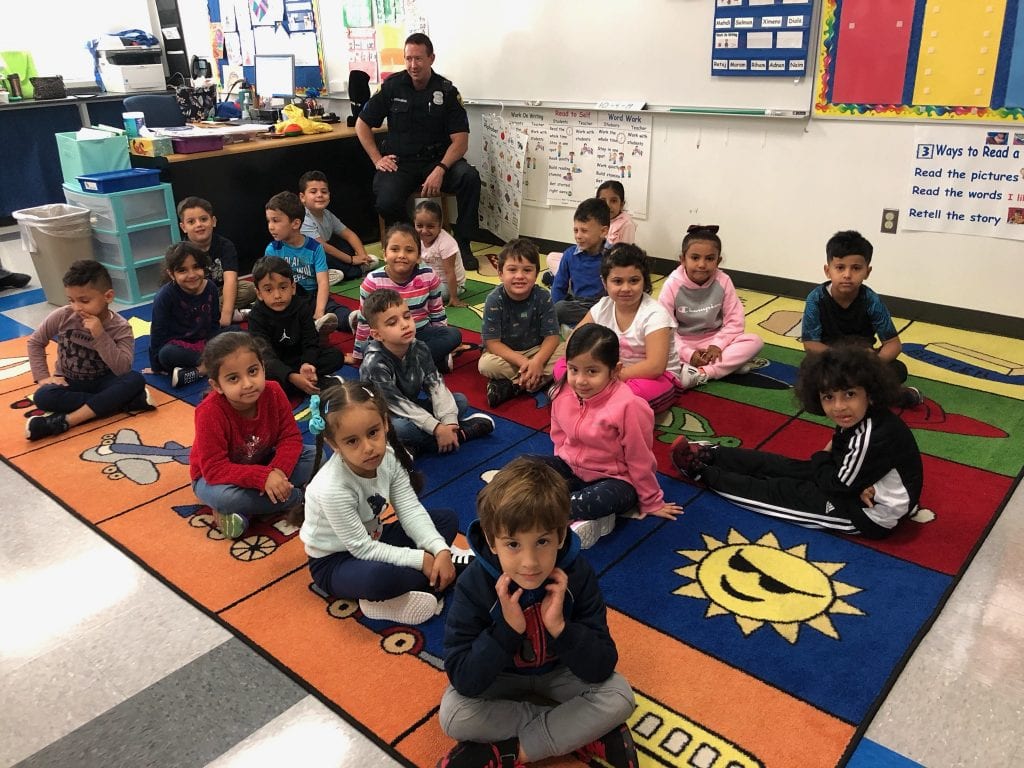 Officer Aaron speaks to our students while they are sitting at the carpet.