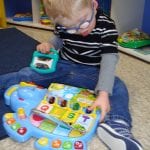 Student playing with toy book