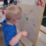 Student painting at easel