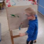 Student painting at easel