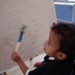 Student painting at easel