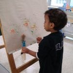 Student painting at easel