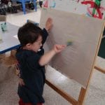 Student painting at easel