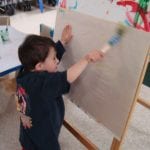 Student painting at easel