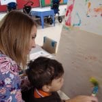 Student painting at easel