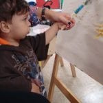 Student painting at easel