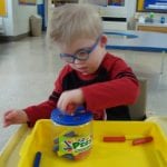 Student working with peg jar