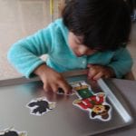 student working with magnet board