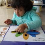 student playing file folder game